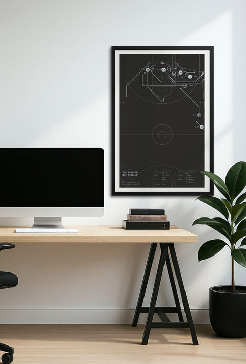Framed “The Memorial Day Miracle” play-diagram poster displayed above a minimalist home-office desk, showing wall scale.